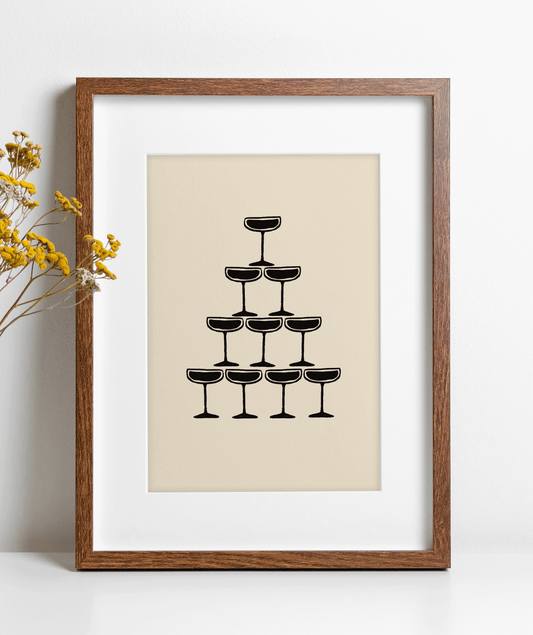 Monochrome illustration of champagne coupe's forming a champagne fountain, framed, leaning against a wall on a kitchen counter