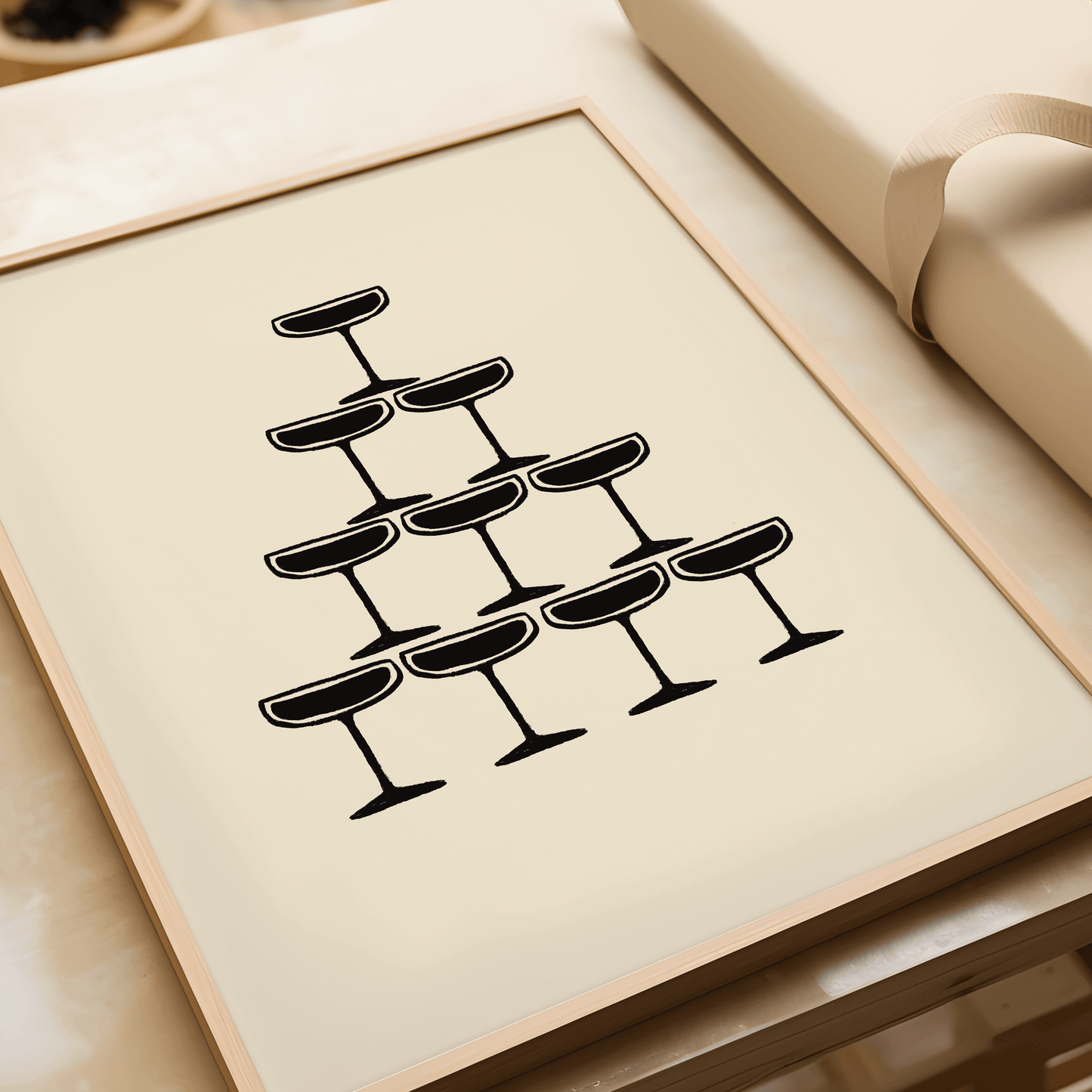 Monochrome illustration of champagne coupe's forming a champagne fountain, framed, laying flat on a table